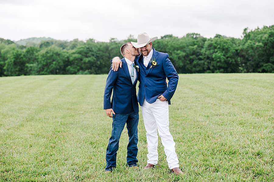 Groom hugging groomsmen at Allenbrooke Farm wedding by Amanda May Photos