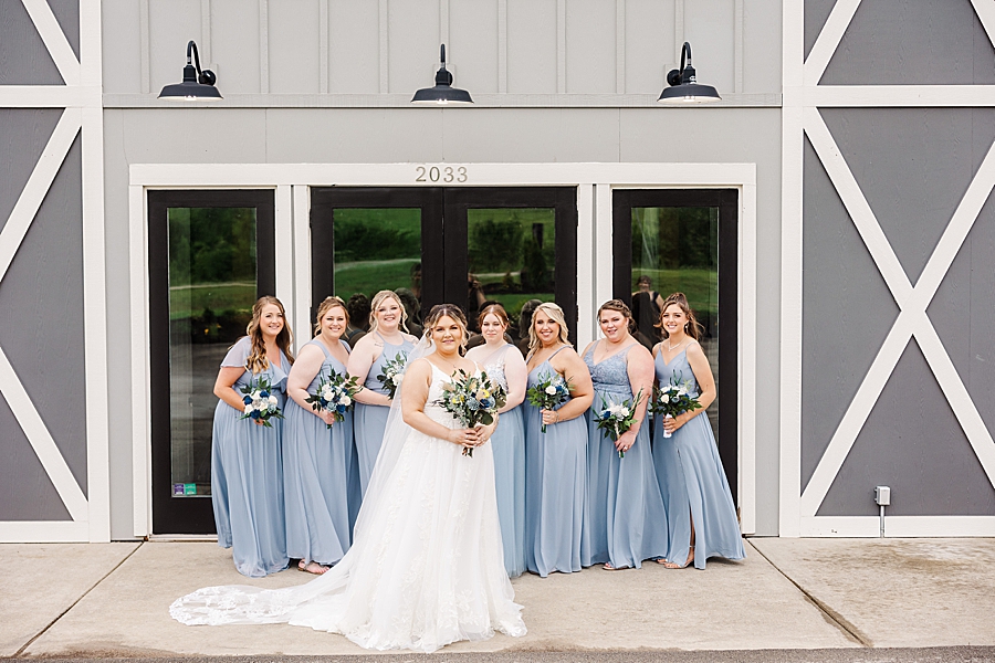 Bride standing in front of bridesmaid at Allenbrooke Farm wedding by Amanda May Photos