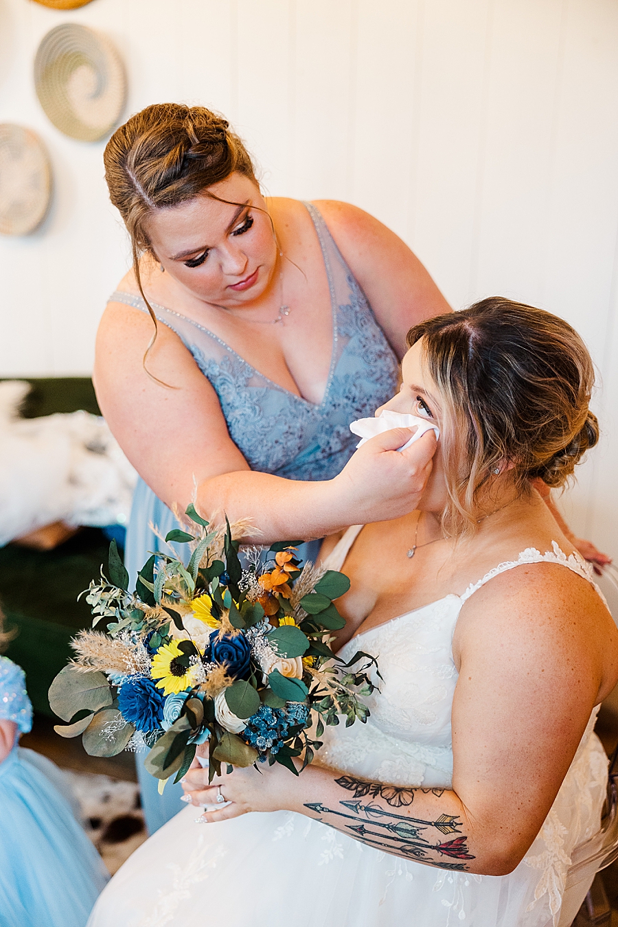 Bridesmaid fixing bride's makeup at Allenbrooke Farm wedding by Amanda May Photos