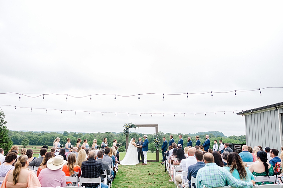 Guests watching bride and groom at Allenbrooke Farm wedding by Amanda May Photos