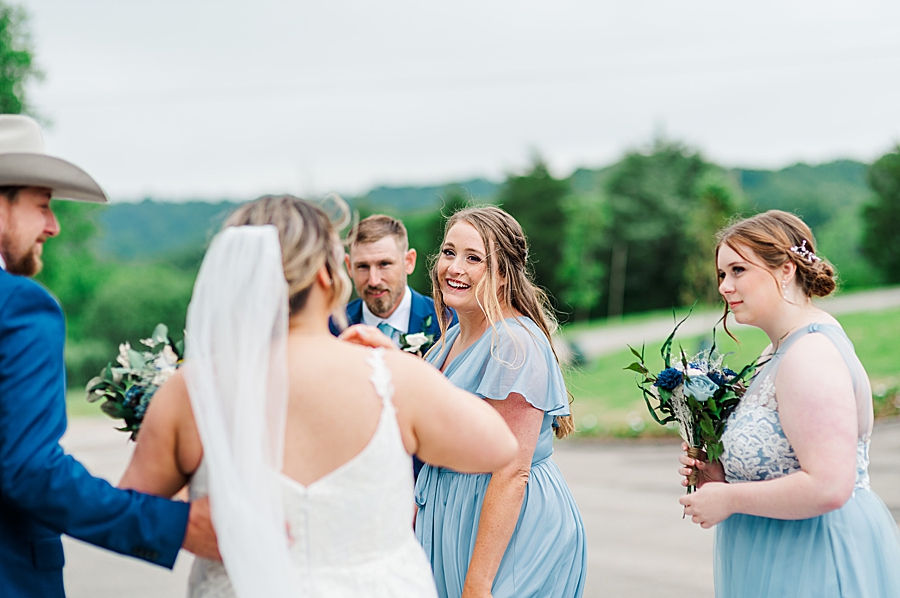 Bridesmaids smiling at bride at Allenbrooke Farm wedding by Amanda May Photos
