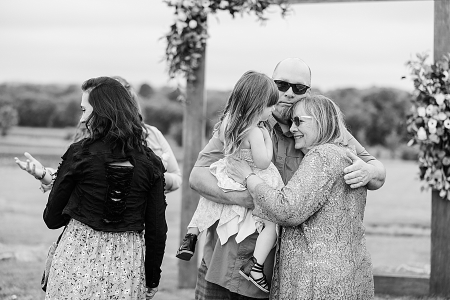 Family hugging at Allenbrooke Farm wedding by Amanda May Photos