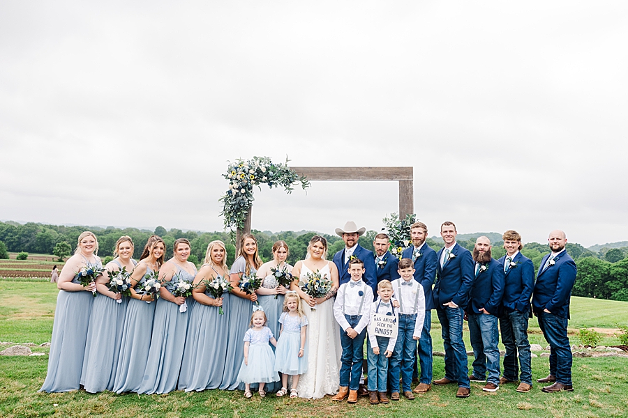 Bride and groom standing with wedding party at Allenbrooke Farm wedding by Amanda May Photos