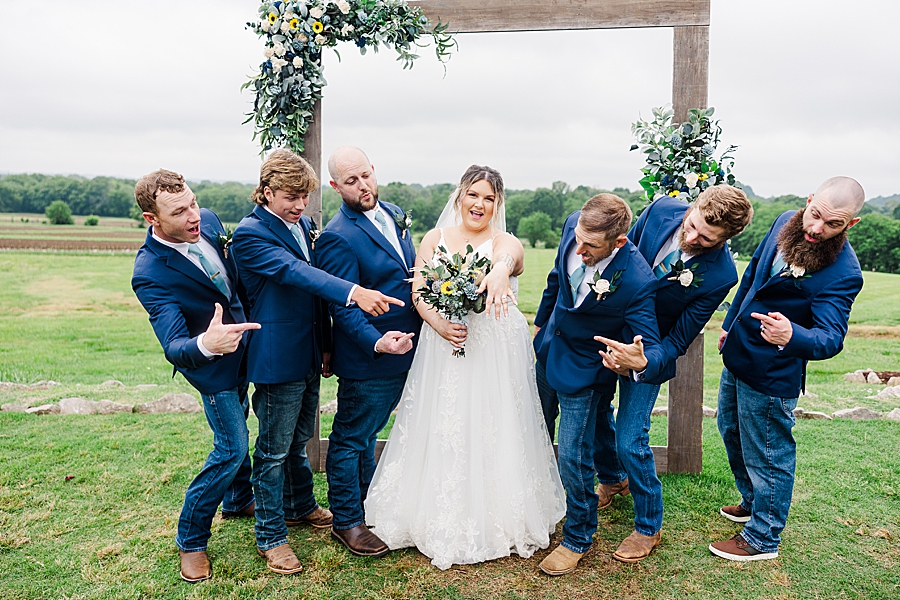 Groomsmen react to ring at wedding by Amanda May Photos