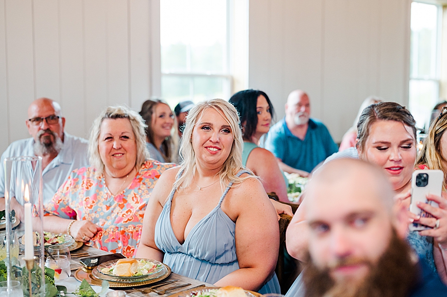 Guests smiling at wedding by Amanda May Photos