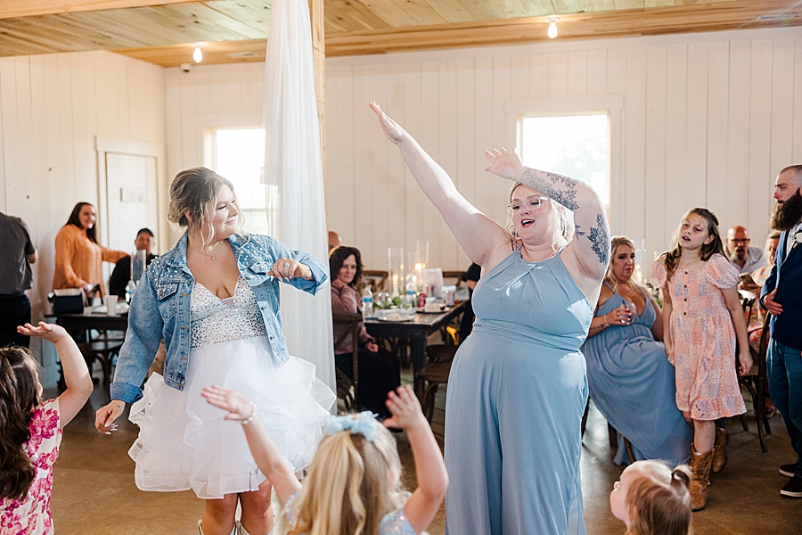 Bridesmaid dancing at wedding by Amanda May Photos