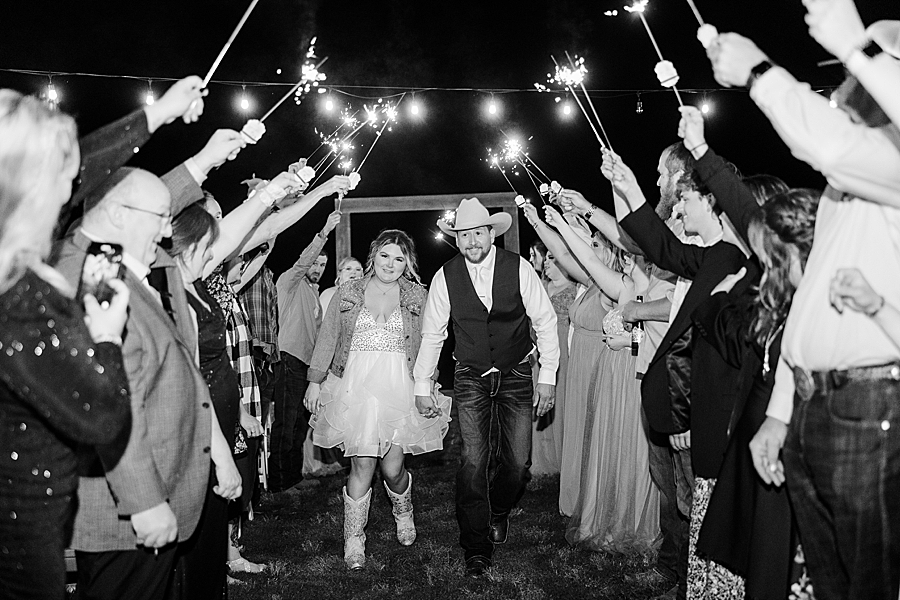 Walking under the sparklers at wedding by Amanda May Photos