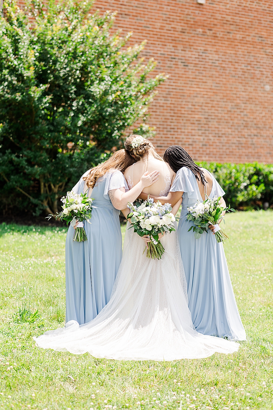 bride hugging bridesmaids