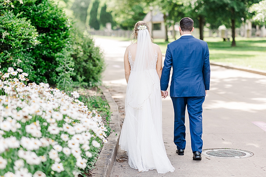 newlyweds walking down path