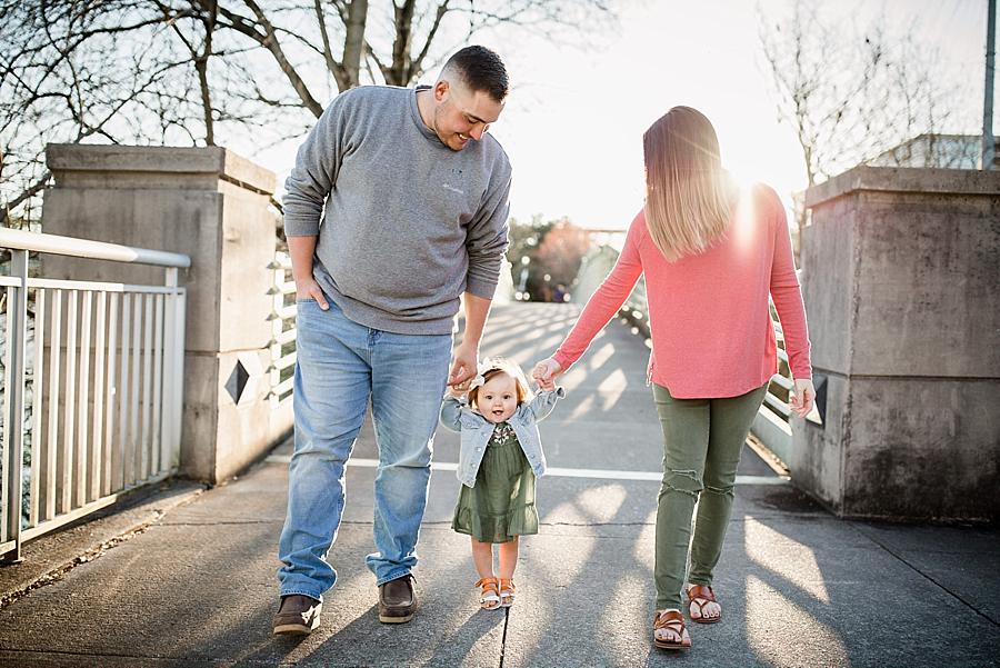 Holding mommy and daddy's hands at this 9 month Volunteer Landing session by Knoxville Wedding Photographer, Amanda May Photos.