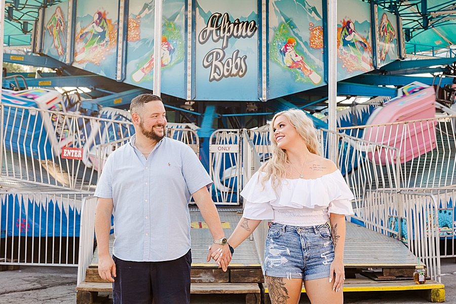 looking at each other at this fair engagement session