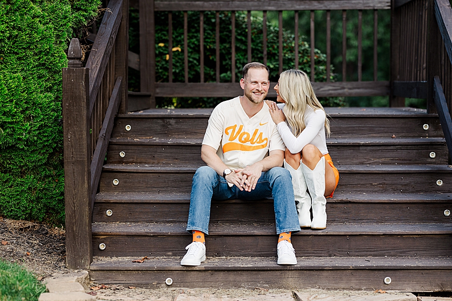 couple sitting on stairs at fall castleton farms engagement