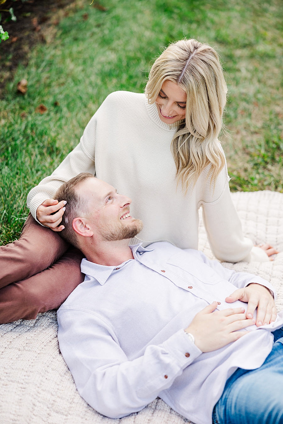 couple cuddling on blanket at fall castleton farms engagement