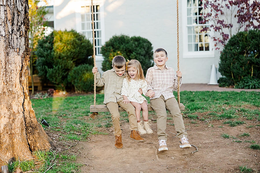 kids on swing at fall family session
