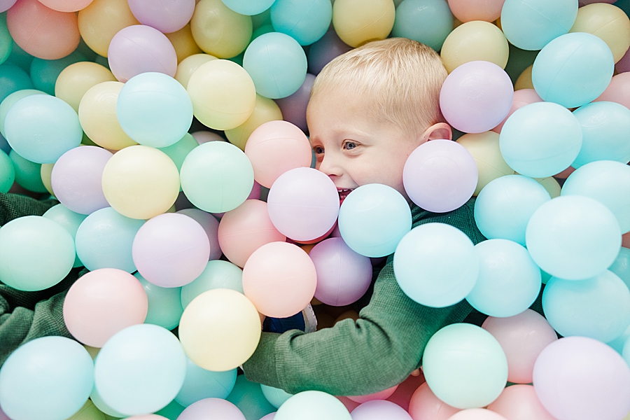 boy in pastel play balls