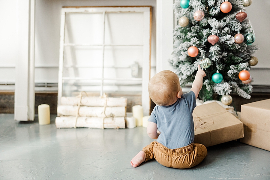 boy playing with christmas tree