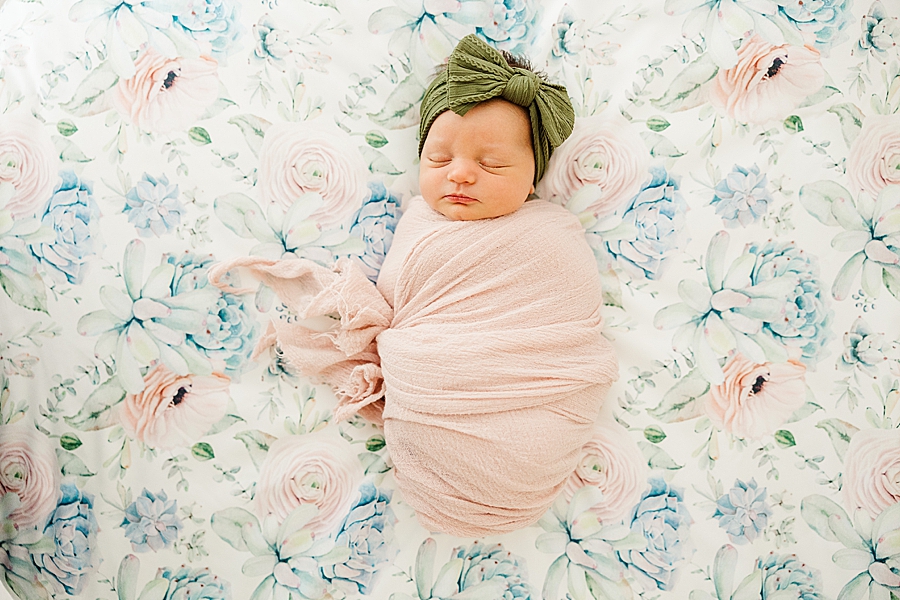 baby on floral newborn blanket