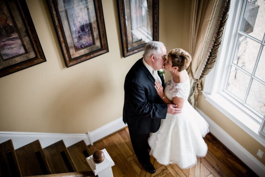 Kissing at the window at this second wedding at WindRiver by Knoxville Wedding Photographer, Amanda May Photos.