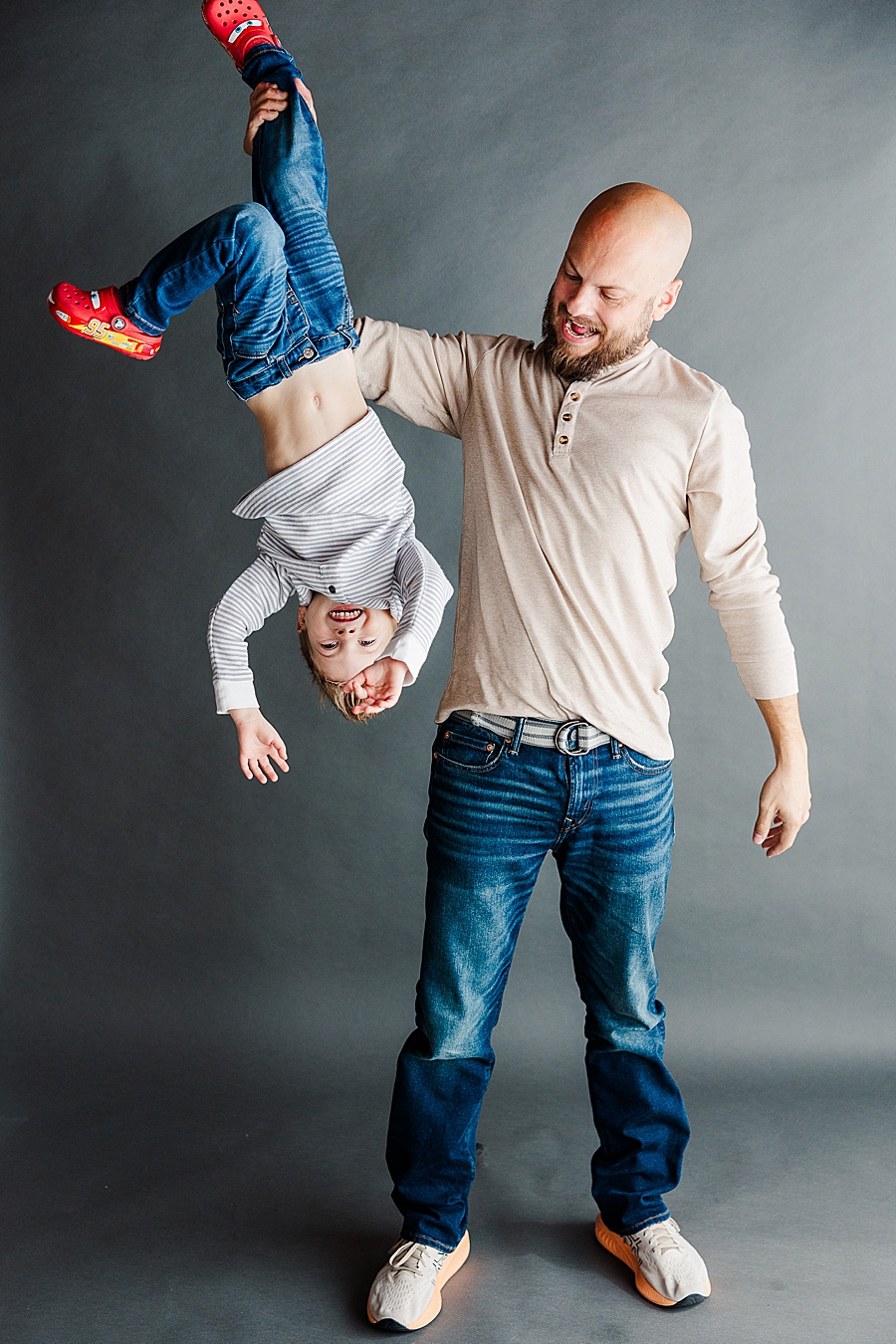 dad holding son by ankle at highlight studio