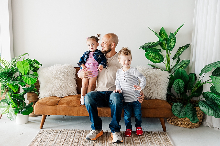 family sitting on highlight studio couch