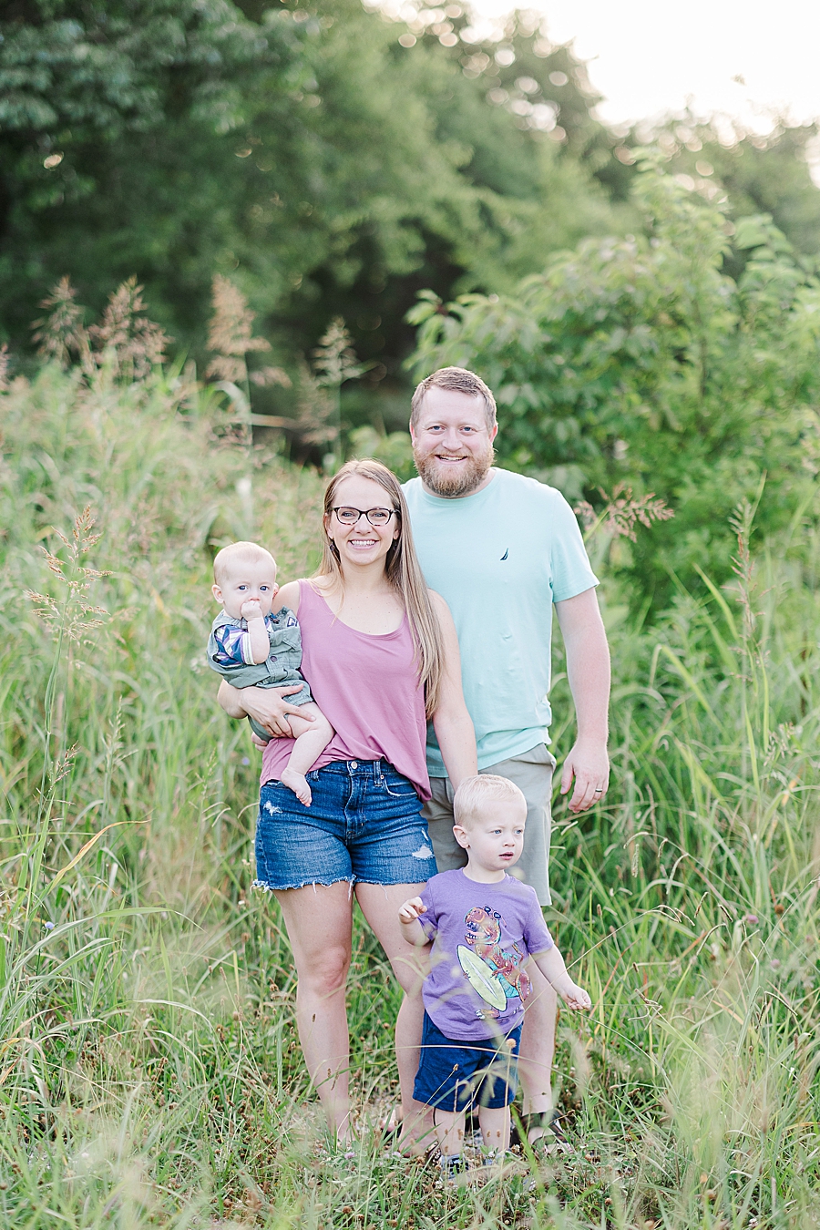 family of four in tall grass