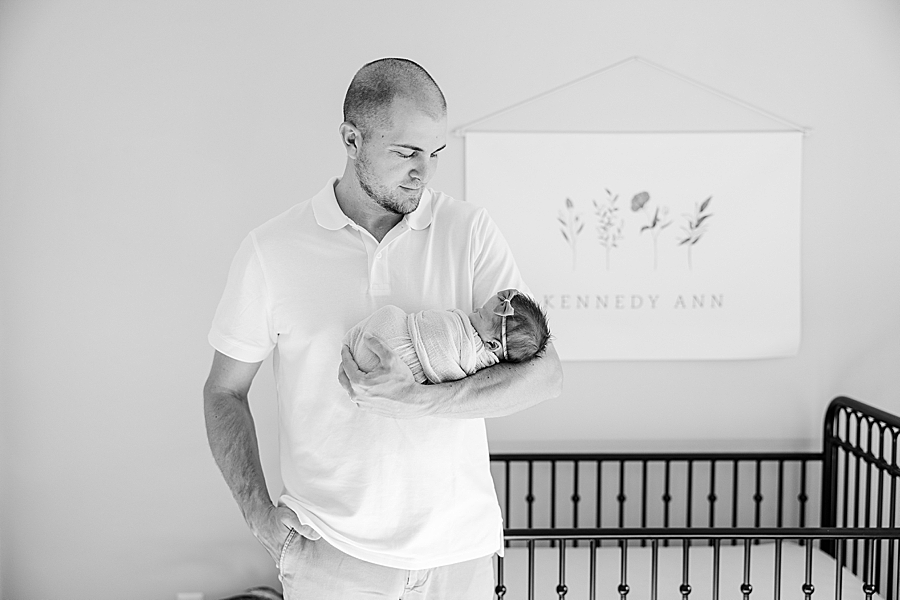 dad holding baby at in home newborn session