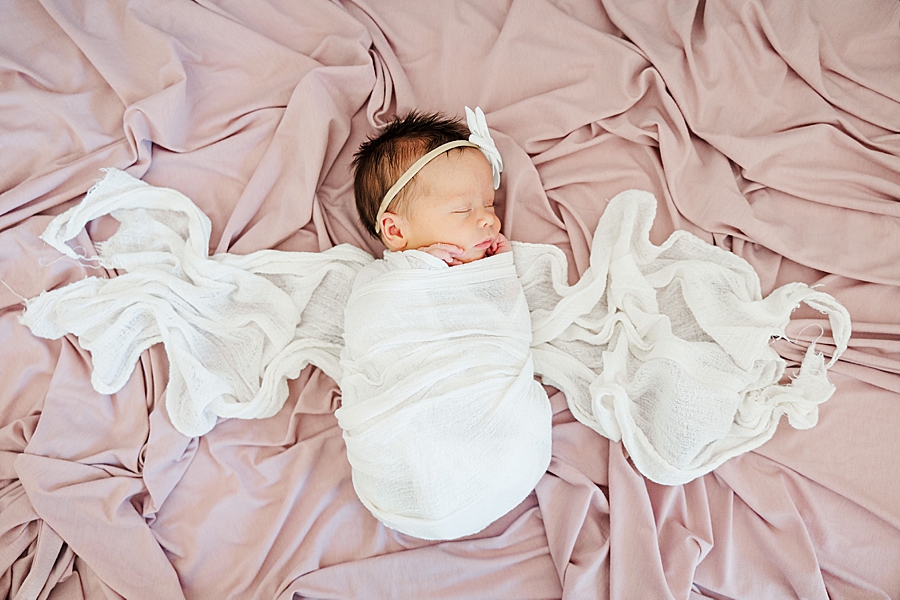 baby in white swaddle at in home newborn session