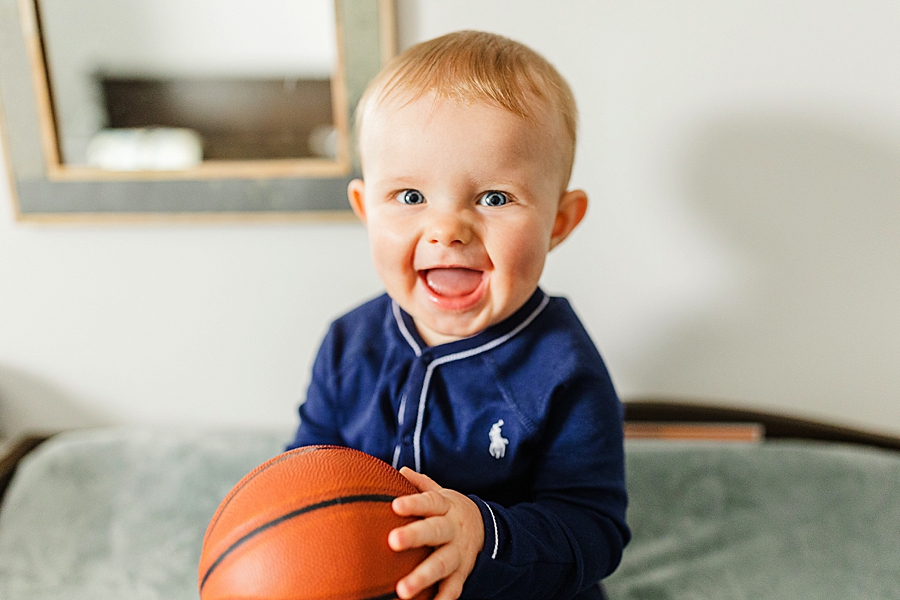baby holding basketball