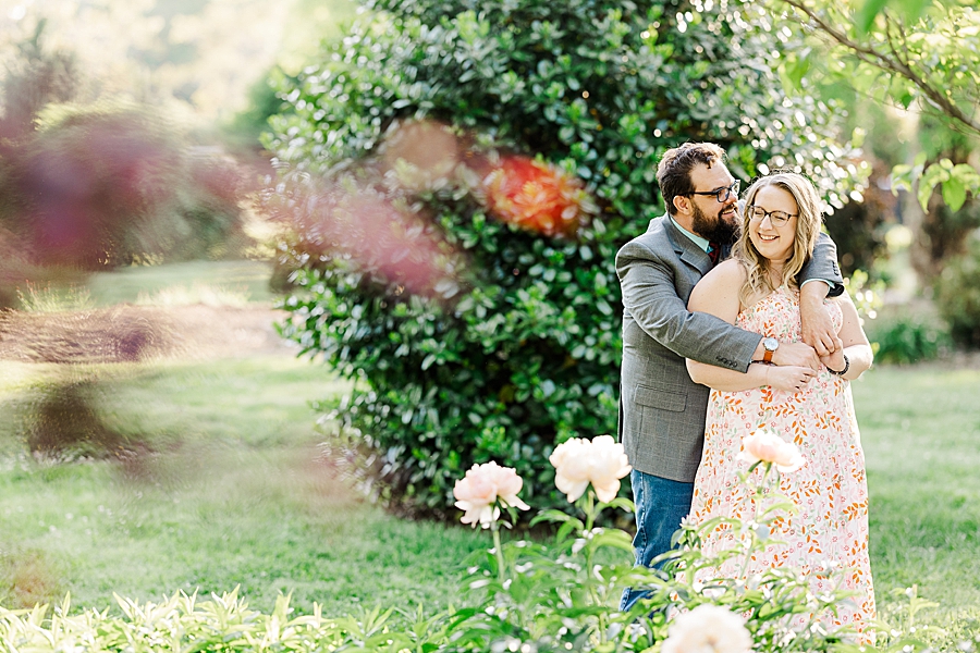 Wrapping his arms around her at UT Gardens Engagement by Amanda May Photos