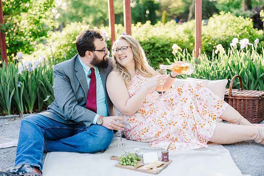 Pouring a glass at UT Gardens Engagement by Amanda May Photos