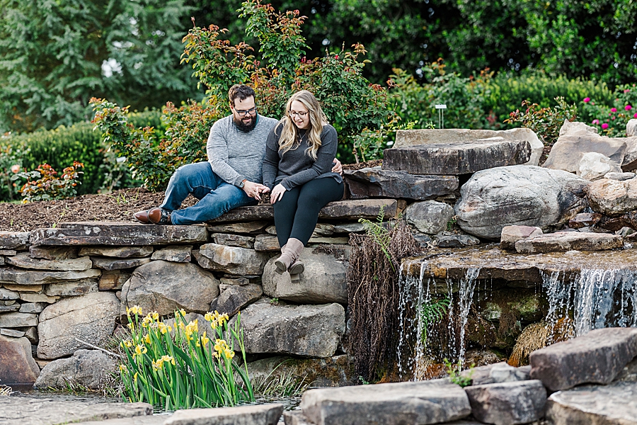 Sitting by the waterfall at engagement session by Amanda May Photos