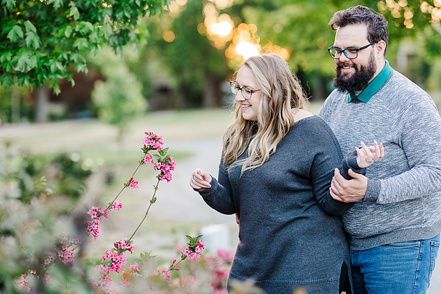 Admiring the flowers at engagement session by Amanda May Photos