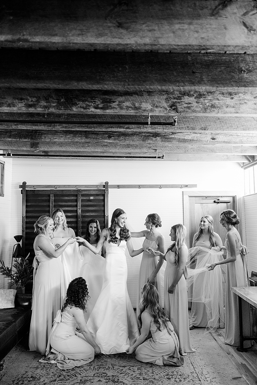 Bridesmaids help bride get ready at Mill & Mine Wedding by Amanda May Photos