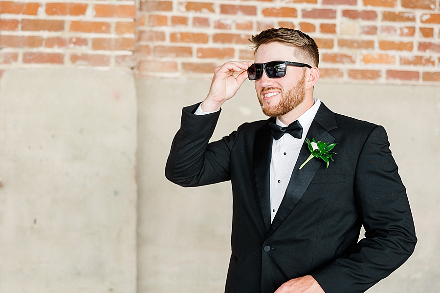 Groom grabs sunglasses at Mill & Mine Wedding by Amanda May Photos