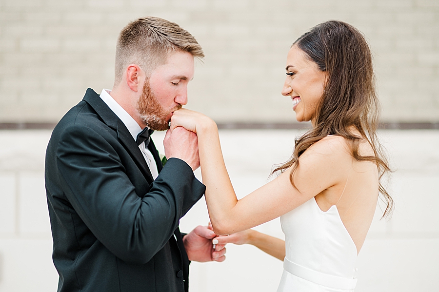 Kissing her hand at Mill & Mine Wedding by Amanda May Photos