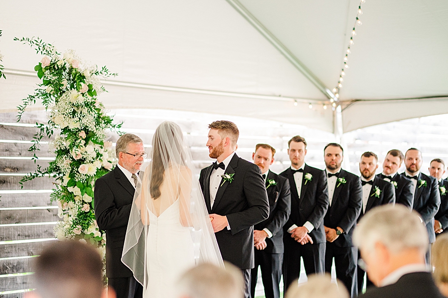 Groomsmen standing at Wedding by Amanda May Photos