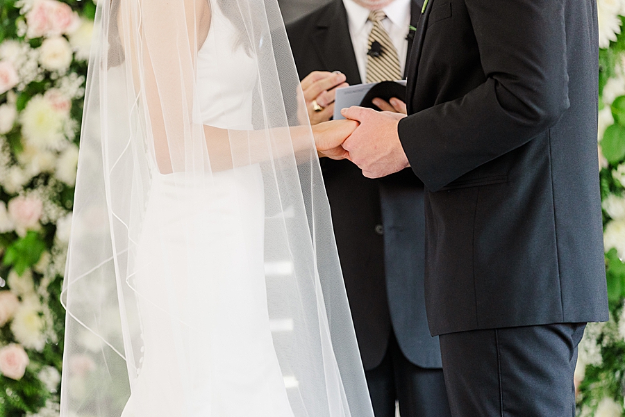 Holding hands during Wedding by Amanda May Photos
