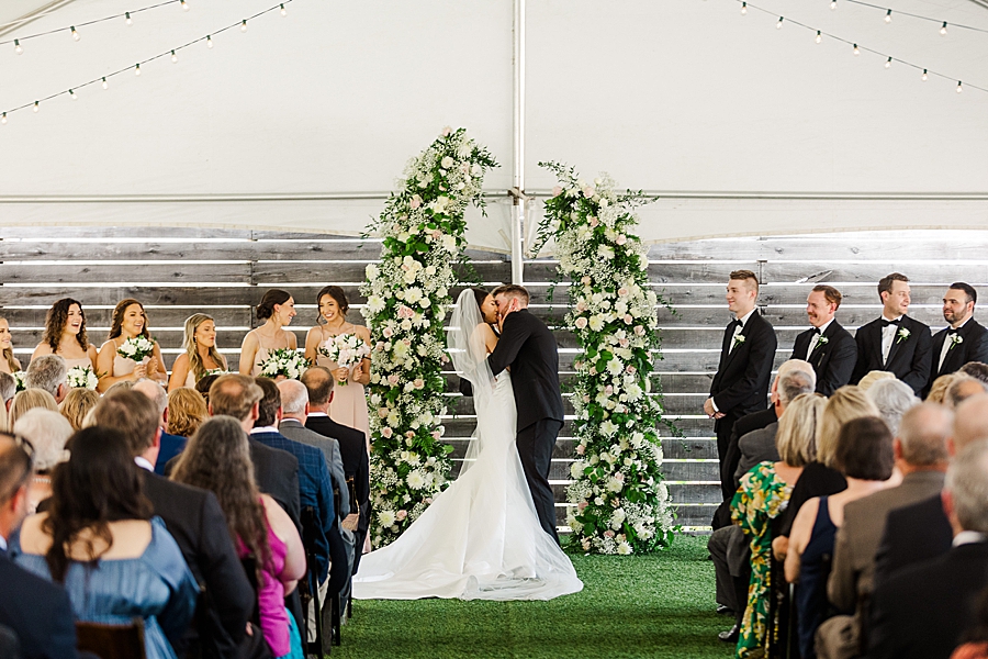 Kissing at the altar at Wedding by Amanda May Photos