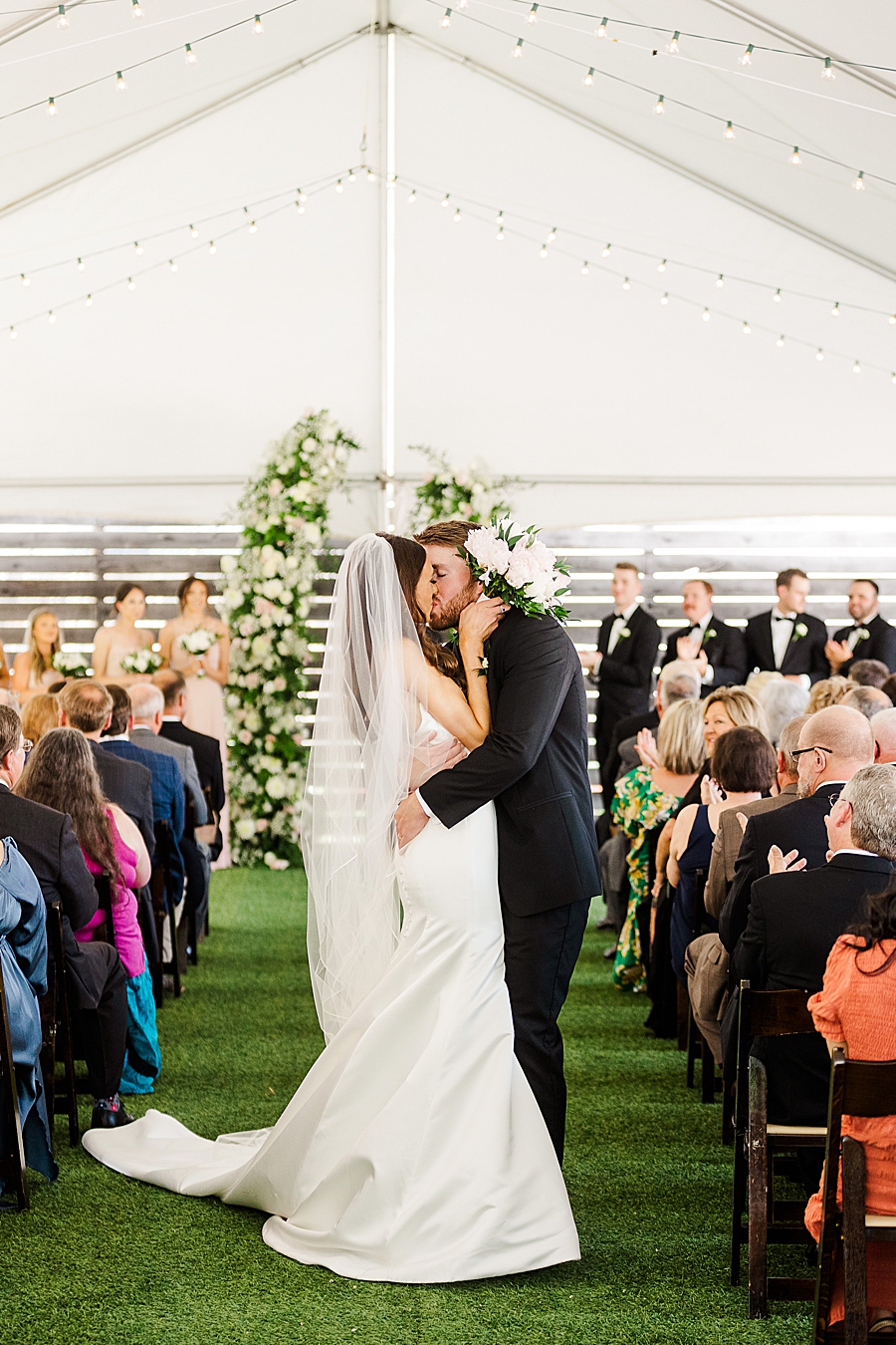 Bride and groom kiss at Wedding by Amanda May Photos