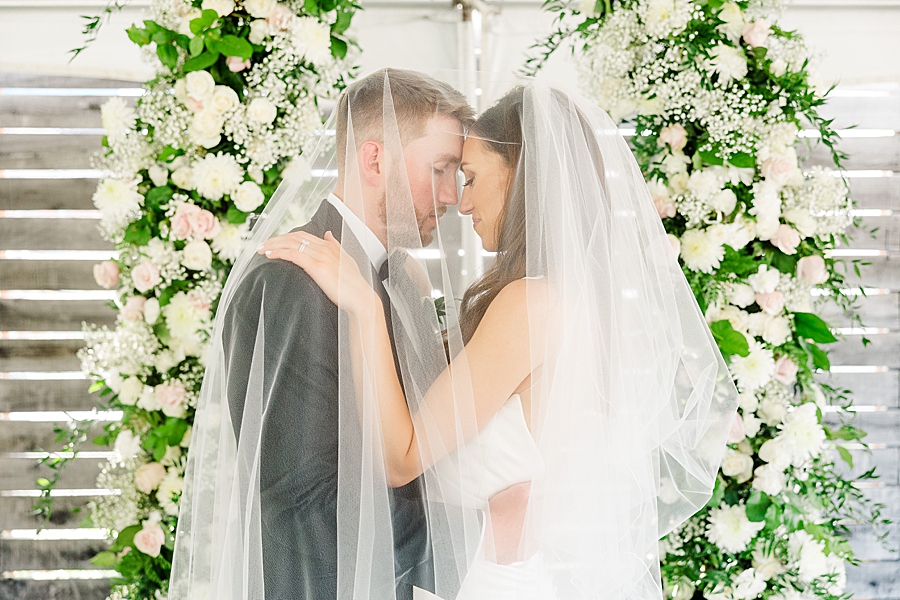 Standing under the veil at Wedding by Amanda May Photos