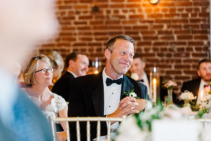 Guests smiling at Wedding by Amanda May Photos