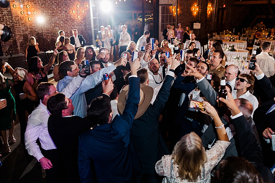 Guests raise glass at Wedding by Amanda May Photos