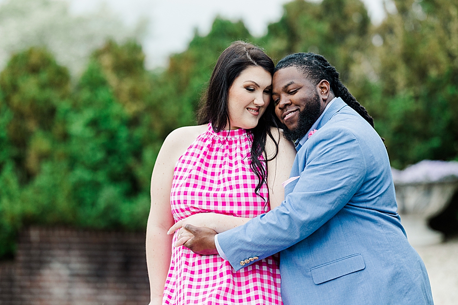 Hugging during Garden Engagement Session by Amanda May Photos