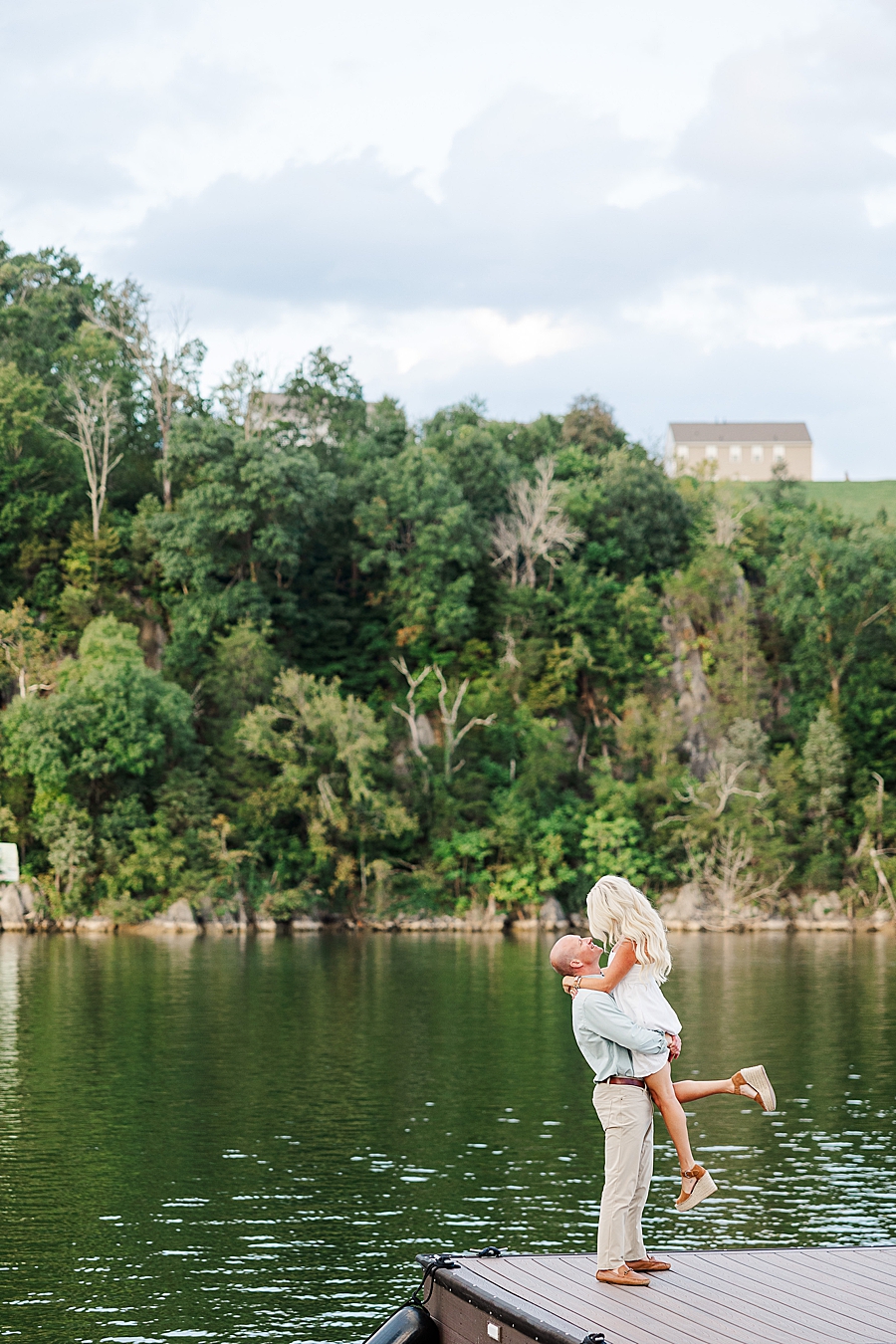 couple by lake at johnson city engagement