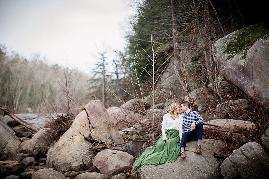 Sitting on the rocks at this Cumberland Falls Engagement session by Knoxville Wedding Photographer, Amanda May Photos.