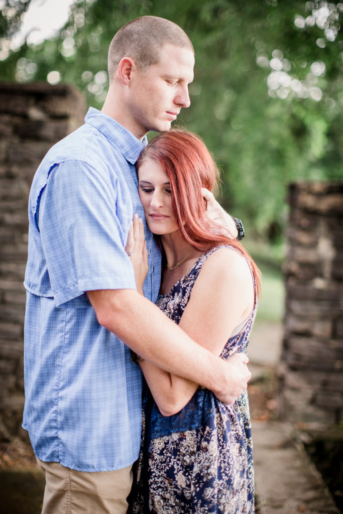 Hugging her close at this Knoxville Botanical Gardens engagement session by Knoxville Wedding Photographer, Amanda May Photos.