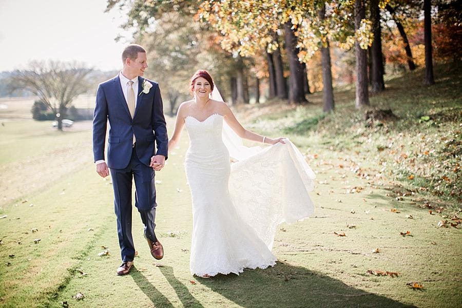 Walking holding out her train at this Holston Hills Country Club wedding by Knoxville Wedding Photographer, Amanda May Photos.