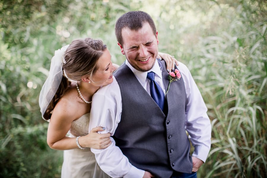 Laughing at each other at this Hillvue Heights Church Wedding by Amanda May Photos.