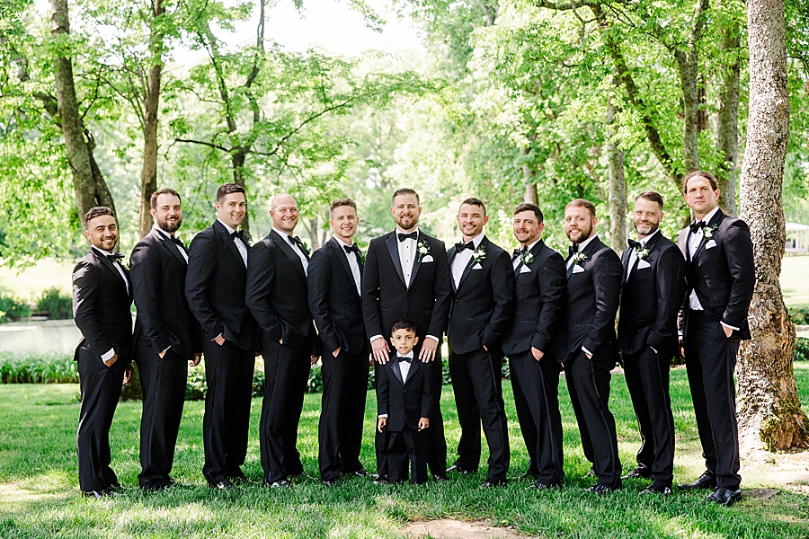 Groom and groomsmen smile at camera at Marblegate Wedding by Amanda May Photos