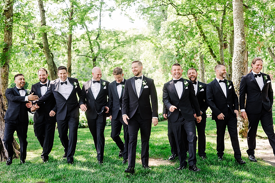 Groom walking with groomsmen at Marblegate Wedding by Amanda May Photos